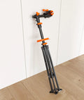 Foldable Bike Repair Stand with Magnetic Tool Tray and 360 Degree Head, folded against a wall, lightweight 6.6kg, max load 66lbs