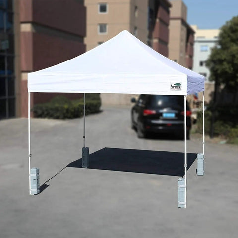 White pop-up tent with 4 Pack Universal Upgraded Canopy Weights For Pop Up Tents Gazebos And Shelters With Easy Wrap Around Hook.