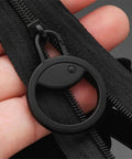 Black detachable metal zipper pull replacement for suitcases luggage backpacks and jackets close-up in hand view