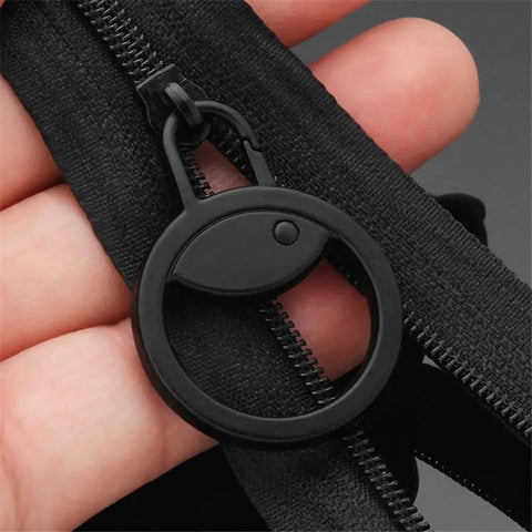 Black detachable metal zipper pull replacement for suitcases luggage backpacks and jackets close-up in hand view