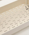 Close-up of smooth beige plastic shelf of Hella Roomy Rolling Storage Organizer Cart with sturdy rubber wheels.