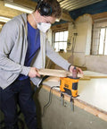 Young man using Heavy Duty 650W Portable Oscillating Spindle Sander With Variable 1800 To 3200 RPM Speed for edge sanding.