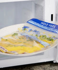 Hand placing Zip N Steam Microwave Safe Food Storage Bags For Meal Prep, Perfect For Steaming Vegetables, Fish, And Chicken, No Cleanup, 10 Count, Healthy Meals In Minutes With Easy Microwave Cooking in microwave