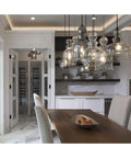 Dope Antique Bronze Champagne Glass Pendant Light With Vintage Woven Cloth Cord, hanging in modern kitchen setting