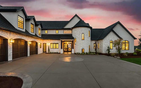 Real Deal Wet Look High Gloss Concrete And Paver Sealer For Exterior Patios featuring five gallon container outside a modern home.