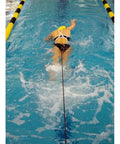 Swimmer using Long Belt Slider for In Water Resistance Training in Green, performing resisted swim-outs in pool.
