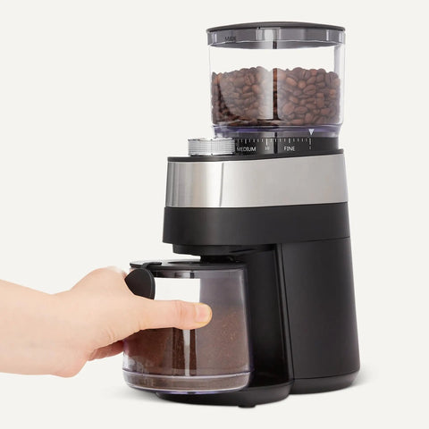 Professional Flat Burr Coffee Grinder With 30 Precision Settings For French Press Drip Coffee And Espresso Anti Static Housing And Six Point Five Ounce Hopper Black with coffee beans in reservoir and ground coffee container.