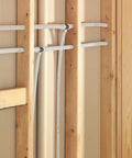 3/4 Inch White PEX Water Tubing Coil, 100 Ft, installed between wooden wall studs, showing flexibility and freeze resistance.
