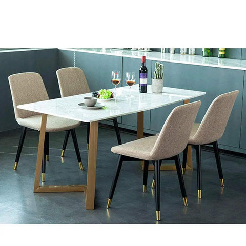 Set Of Two Heavy Duty Steel Table Legs For Kitchen Dining Tables And Craft Benches With Adjustable Leveling Feet Built Like A Tank To Carry Serious Weight In Matte Black Or Brass Shades under a marble table with beige chairs.