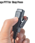 Hand holding Universal 2 Pin K1 To 3.5mm Earpiece Adapter Cable With Built In Mic And PTT showcasing large PTT button.