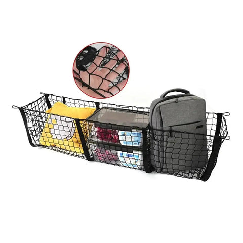 Multi Compartment Truck Bed Cargo Net For Tesla Cybertruck 2024 holding a backpack, groceries, and supplies securely in a truck bed.