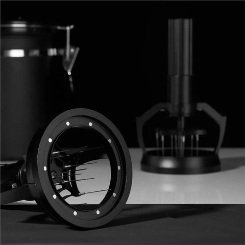 Close-up of 58mm Electric Espresso Stirrer And Wdt Tool With Fine Needles for smashing coffee clumps on a black background.