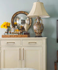 White dresser with 10 Pack 5 Inch Vintage Antique Brass Cabinet Pulls For Kitchen Cabinets And Dressers, ornate lamp, and decorative mirror.