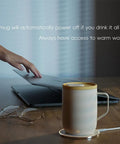 Cordless Smart Coffee Mug Warmer Plate with Digital Temperature Control on desk beside laptop for office use.