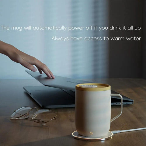 Cordless Smart Coffee Mug Warmer Plate with Digital Temperature Control on desk beside laptop for office use.