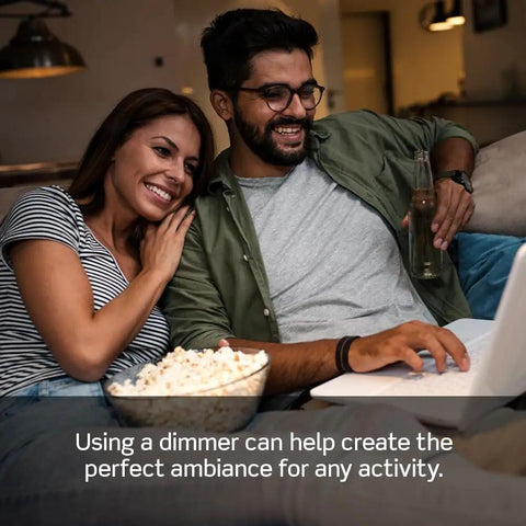 Couple enjoying a movie at home with popcorn, using SureSlide Dimmer Switch For Dimmable LED Halogen And Incandescent Bulbs Model 6672-1LW