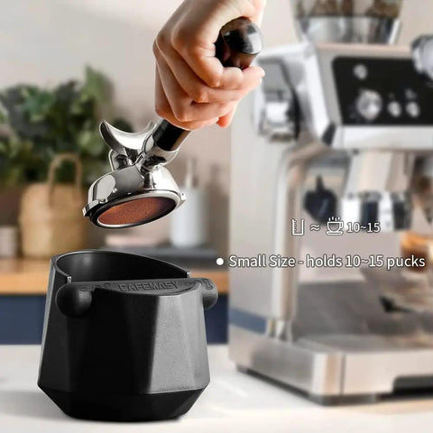 Hand using espresso machine over diamond shape mini espresso knock box for home use quick coffee grounds cleanup with included cleaning brush barista essential