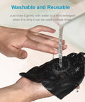 Black microfiber cleaning cloth being wrung under running water for glasses and screens.