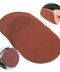 25 Piece Hook And Loop Sanding Discs Assortment Featuring 40 To 3000 Grit Sizes stacked, showcasing red aluminum oxide for polishing.