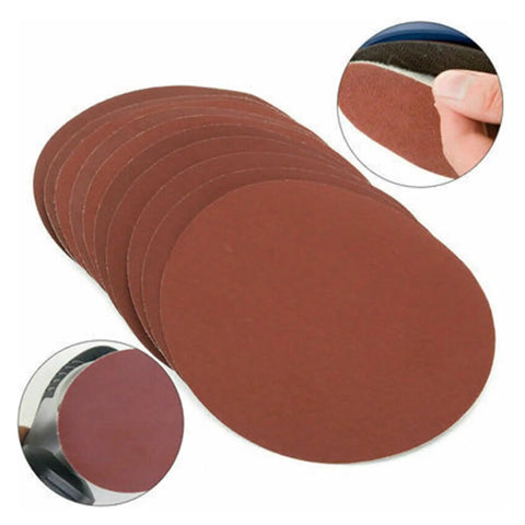 25 Piece Hook And Loop Sanding Discs Assortment Featuring 40 To 3000 Grit Sizes stacked, showcasing red aluminum oxide for polishing.