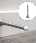 Six Pack Flexible Three And Three Quarter Inch Spring Door Stopper Set With Rubber Bumper And Screws Included For Bottom Of Door Keeps Walls Safe Durable Steel Nickel Finish. Installed on baseboard with close-up view.