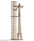 Wooden 3D rocket model kit fully assembled with launch pad, part of Hands On 3D Wood Puzzle For Adults SpaceX Starship Super Heavy Booster DIY Rocket Model Kit And STEM Educational Toy With Impressive Desk Decor For Space Lovers Great Gift For Adults And Teens Who Love Rockets And Space.