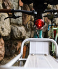 Close-up of bike with Eco Bike Rack With Oversized 6061 Aluminum Rod, open side rails for heel clearance, and rear light installed.