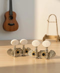 Premium White Ukulele Tuner Pegs And Keys With Smooth Gear Action Compact Metal Alloy Machine Heads Featuring Decorative Plates Easy Install Hardware Set For Seamelss Sound on wooden table.