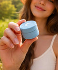 Woman holding blue Compact Manual Spice Crusher For Kitchen And Outdoors No Battery Needed Hand Crank Metal Grinder.