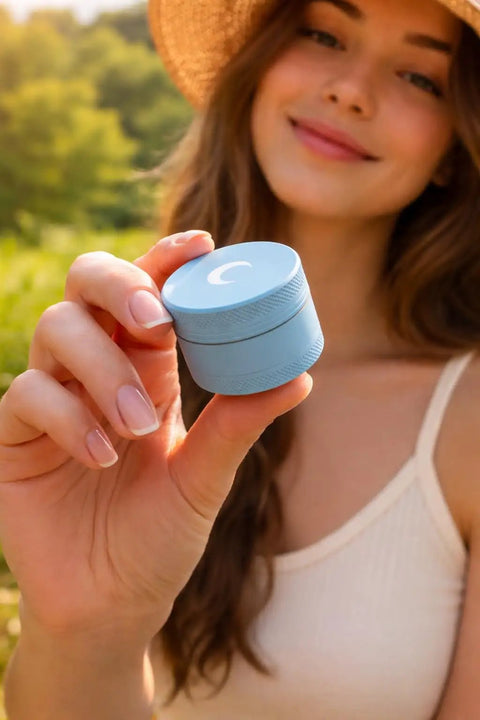 Woman holding blue Compact Manual Spice Crusher For Kitchen And Outdoors No Battery Needed Hand Crank Metal Grinder.