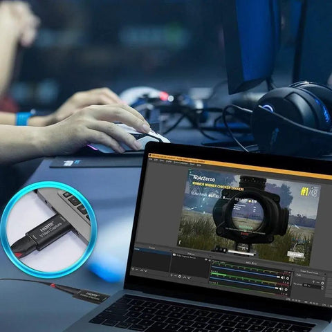 Laptop streaming gaming content with HDMI video capture card setup, close-up of connection in use, showing game on screen.