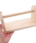 Hand holding solid wood tape dispenser with razor sharp blade for clean desk organization and tidy workspace.