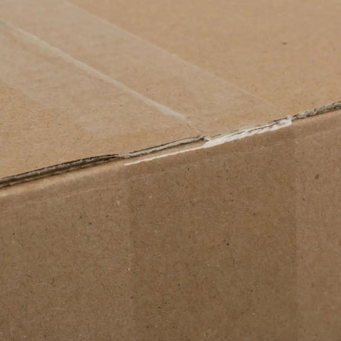 Close-up of sealed cardboard box using Six Roll Pack Of High Performance Clear Packing Tape Refills For Shipping Moving Mailing And Storage Boxes