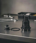 Driver Hub Body For XD XDR 11 12 Speed Cassettes Aluminum Alloy Wheel Hub Part on workbench, with ring and smaller adapter