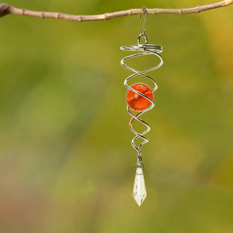 Stainless Steel Wind Spinner Tail Gazing Ball Stabilizers For Indoor And Outdoor Decor With Hanging Swivel Hook Glass Ball Accent Weatherproof Garden Ornament Kit To Elevate Patio And Yard Vibes. Hanging stainless steel wind spinner with orange glass ball and clear pendant on branch