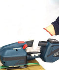Heavy Duty Electric Strapping Tool For 13Mm To 16Mm Pp Pet Straps with a hand operating it on a package.