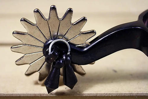 Close-up of Black Steel Western Jingle Bob Spurs for Men with 16-point rowel and jingle, showing durable black steel material