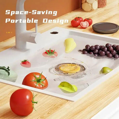 Cordless Electric Produce Washer And Veggie Scrubber Driven By Smart Electrolytic Tech cleaning fruits in a kitchen sink.