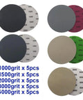 25 Pack Premium 5 Inch Hook Loop Sandpaper Discs Wet Dry Grit Levels 1000 To 5000 Silicone Carbide assorted grit discs laid out.