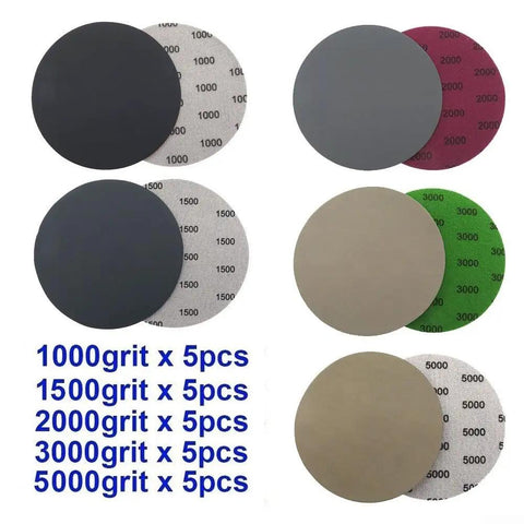25 Pack Premium 5 Inch Hook Loop Sandpaper Discs Wet Dry Grit Levels 1000 To 5000 Silicone Carbide assorted grit discs laid out.