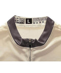Close-up of a beige jacket collar with zipper and label showing size L and care instructions