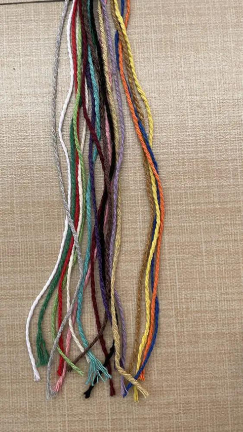 Macrame Cord 1.5mm Cotton String Rope For DIY Crafts 109 Yards With 35 Color Options shown in various bright colors on a surface