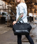 Person carrying Deluxe 16 Inch Canvas Tool Bag With 13 Pockets And Detachable Shoulder Strap Large Heavy Duty Organizer