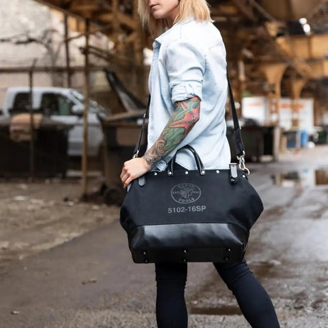 Person carrying Deluxe 16 Inch Canvas Tool Bag With 13 Pockets And Detachable Shoulder Strap Large Heavy Duty Organizer