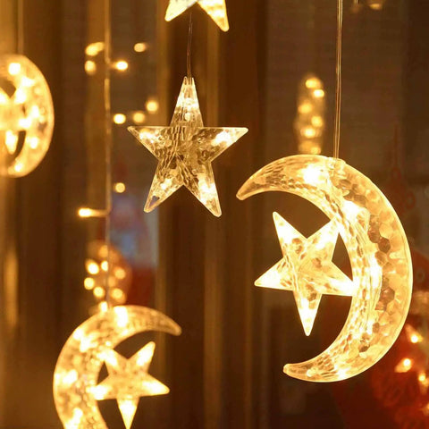 Solar String Lights Outdoor for Ramadan Eid Decor, 138 LED Star Moon Curtain Lights glowing warmly in dark.