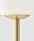 Close-up of Luna LED Floor Lamp Dope Modern Tall Light For Living Rooms And Home Offices With Frosted Glass Globe in brass finish.