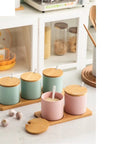 Top Shelf Ceramic Coffee Storage Jar With Secure Wooden Lid And Airtight Design Keeps Daily Grind Sugar Salt Tea Fresh As Ever While Looking Slick On Any Modern Counter Space, displayed in pastel colors on a wooden tray.