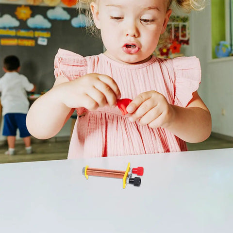 Child exploring Two Pack T Shaped Solenoid Electromagnet Coil Kit For Hands On Physics Experiments on a classroom table