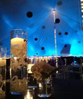 Elegant event setting with Pack Of 4 Wax Flickering LED Floating Candles 3 Inch Tealights Waterproof Warm White Battery Operated.