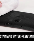 Close-up of black stain-resistant Silky Memory Foam Wrist Rest For Keyboard and Mouse with water and cloth.